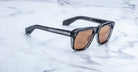 Jacques Marie Mage Yves black rectangular sunglasses with UV-protection brown lenses, top view.