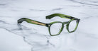 Jacques Marie Mage Zephirin 47 rectangular eyeglasses with thick green frames and gold accents, front view.