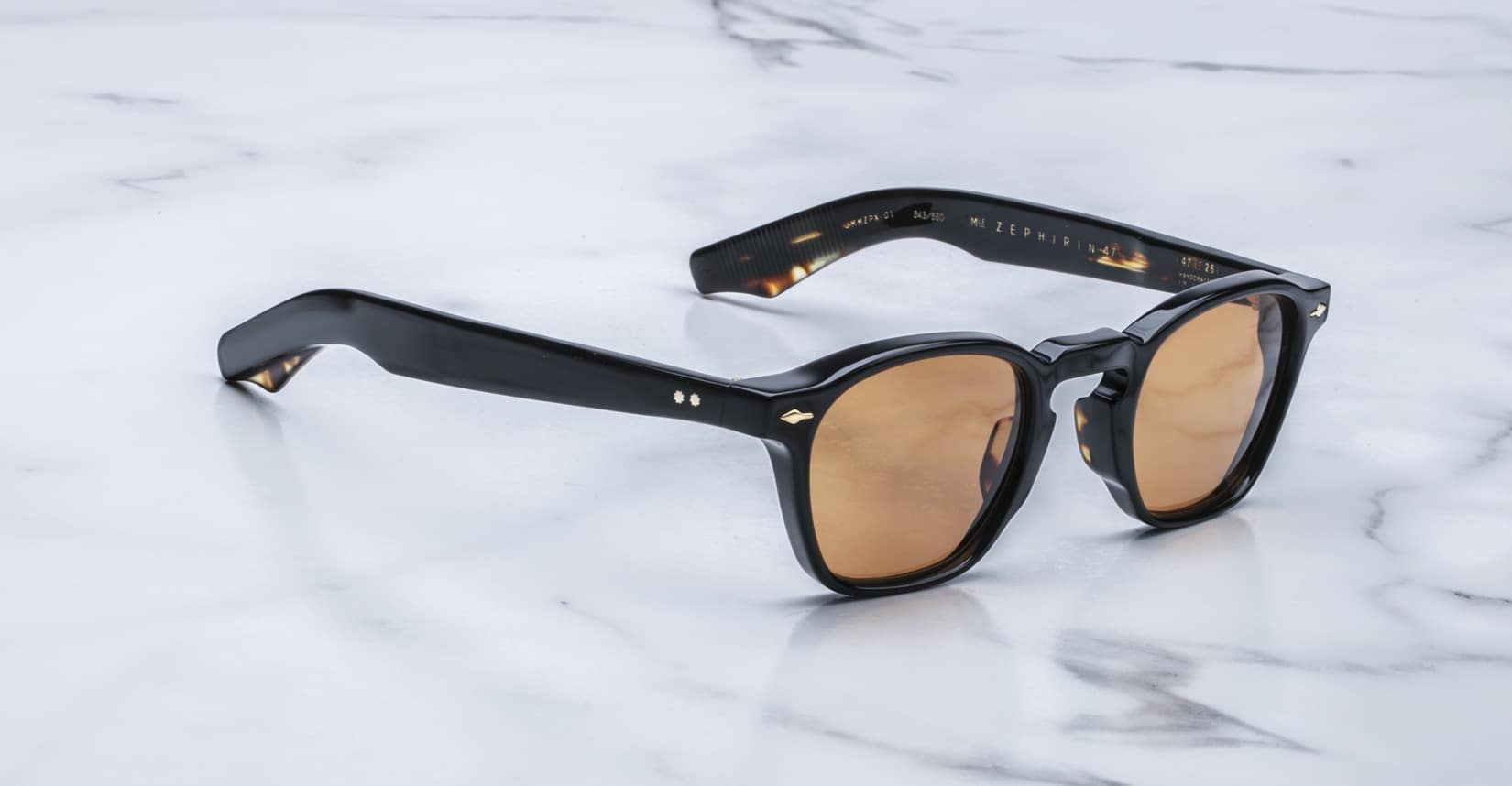 Jacques Marie Mage Zephirin 47 black-framed sunglasses with brown lenses, top view.