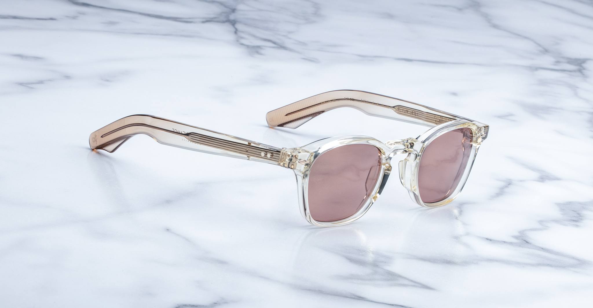 Jacques Marie Mage Zephirin 47 sunglasses with pink lenses and light brown temples, shown from above.