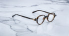 Jacques Marie Mage The Clark round eyeglasses, front view, classic design.
