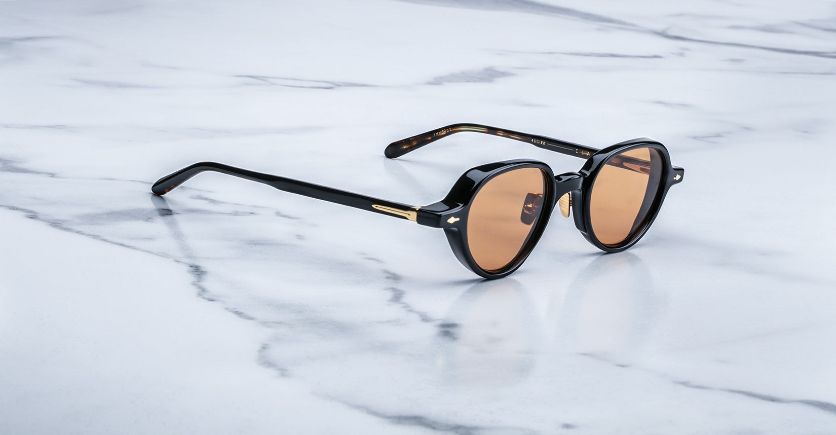 Jacques Marie Mage The Clark round sunglasses with black frames and brown lenses, shown from the front.