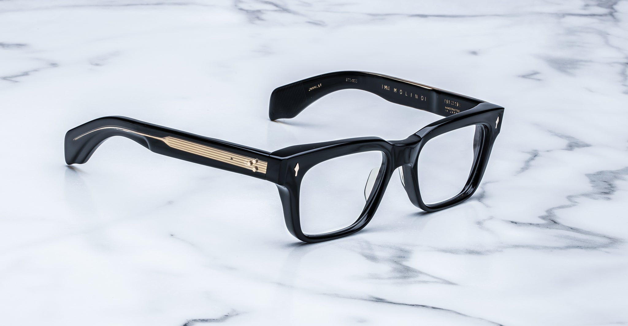 Jacques Marie Mage Molino black rectangular eyeglasses with gold temple accents, front view.