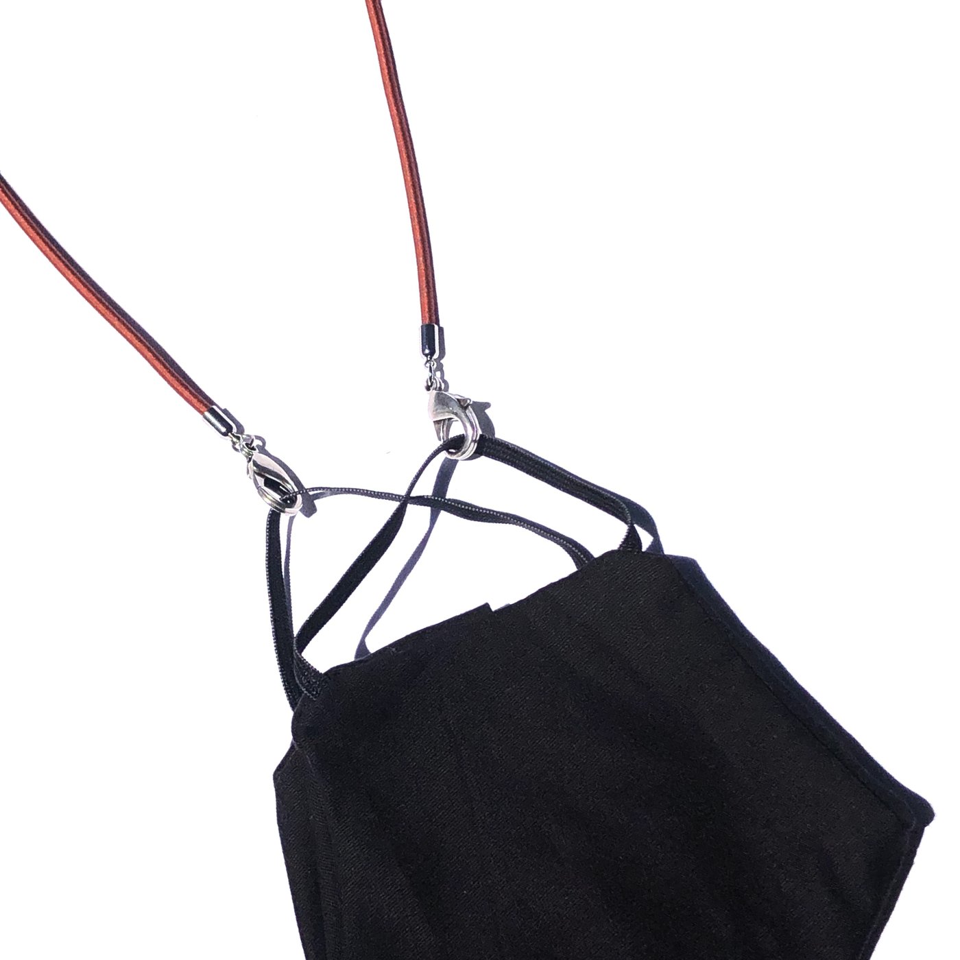 A black face mask with ear loops is attached to the Stretch Cord Necklace Chain for Face Masks with silver clasps, displayed on a white background.