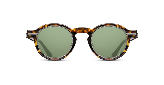 The Matsuda M2050 sunglasses feature round green lenses and a tortoiseshell-patterned frame, displayed against a white background.