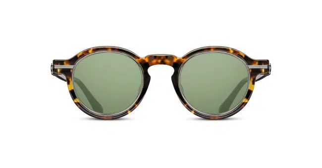 The Matsuda M2050 sunglasses feature round green lenses and a tortoiseshell-patterned frame, displayed against a white background.