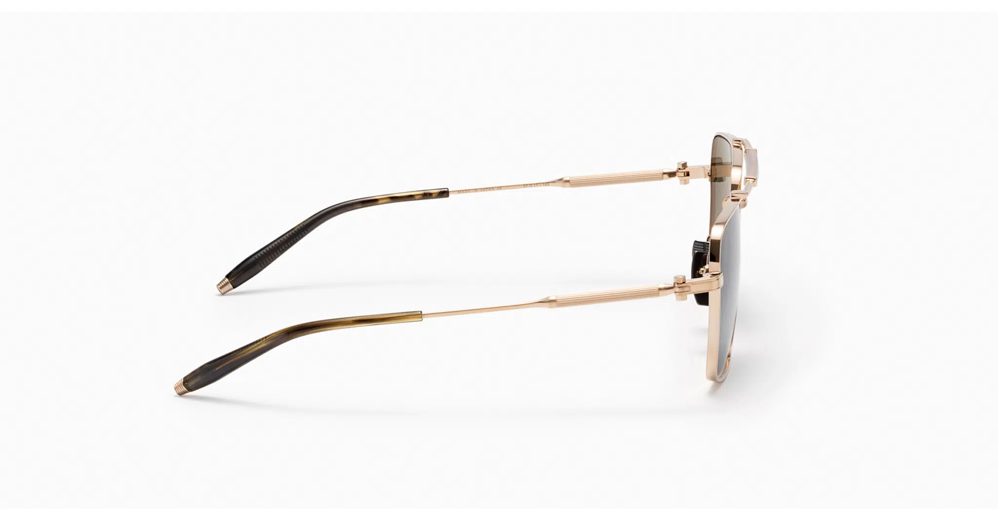 A side view of the Akoni Eos sunglasses, featuring stylish gold frames, thin metal arms, and black ear tips, photographed on a white background.