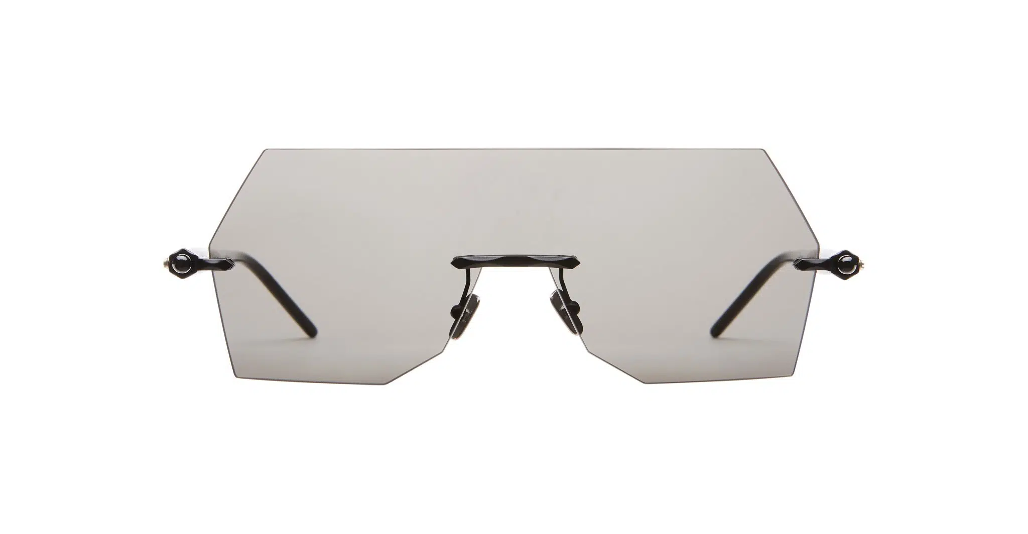 The Kuboraum P90 features a rimless design with large, geometric tinted lenses and thin black arms, shown against a white background.