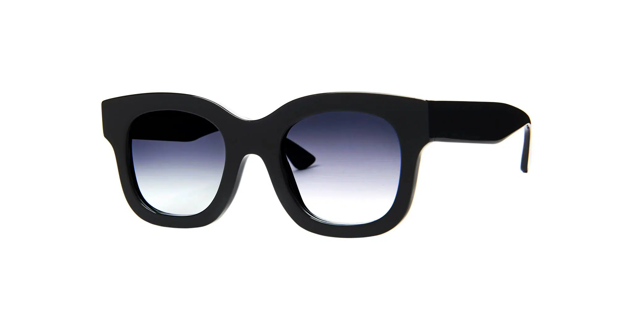 The Thierry Lasry Unicorny features black, thick frames with square lenses and a dark gradient tint, displayed on a white background.