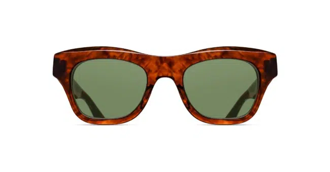 Matsuda M1027 tortoiseshell sunglasses with thick brown marbled frames and green tinted lenses, displayed front-facing on a white background.