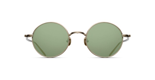 The Matsuda M3087 features round green-tinted lenses and slim metallic gold frames, displayed from the front against a white background.