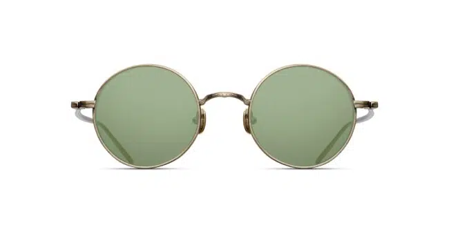 The Matsuda M3087 features round green-tinted lenses and slim metallic gold frames, displayed from the front against a white background.