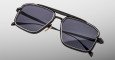 The Jacques Marie Mage Earl sunglasses feature a rectangular black frame, dark tinted lenses, and a double bridge design, shown against a plain light gray background.