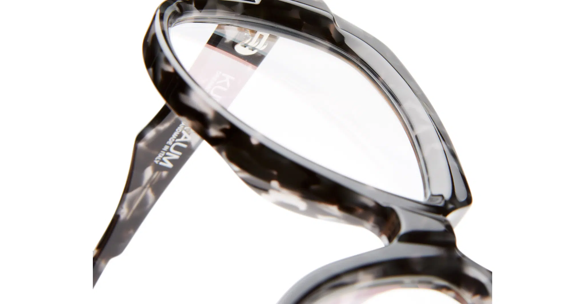 Close-up view of Kuboraum K37 eyeglasses featuring black and white tortoiseshell frames, set against a white background.