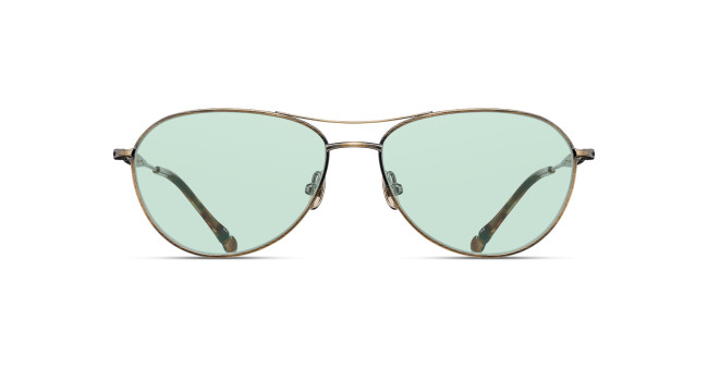 The Matsuda M3139 features aviator-style sunglasses with thin metal frames and light green-tinted lenses, displayed from the front on a white background.