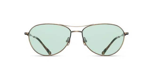 The Matsuda M3139 features aviator-style sunglasses with thin metal frames and light green-tinted lenses, displayed from the front on a white background.