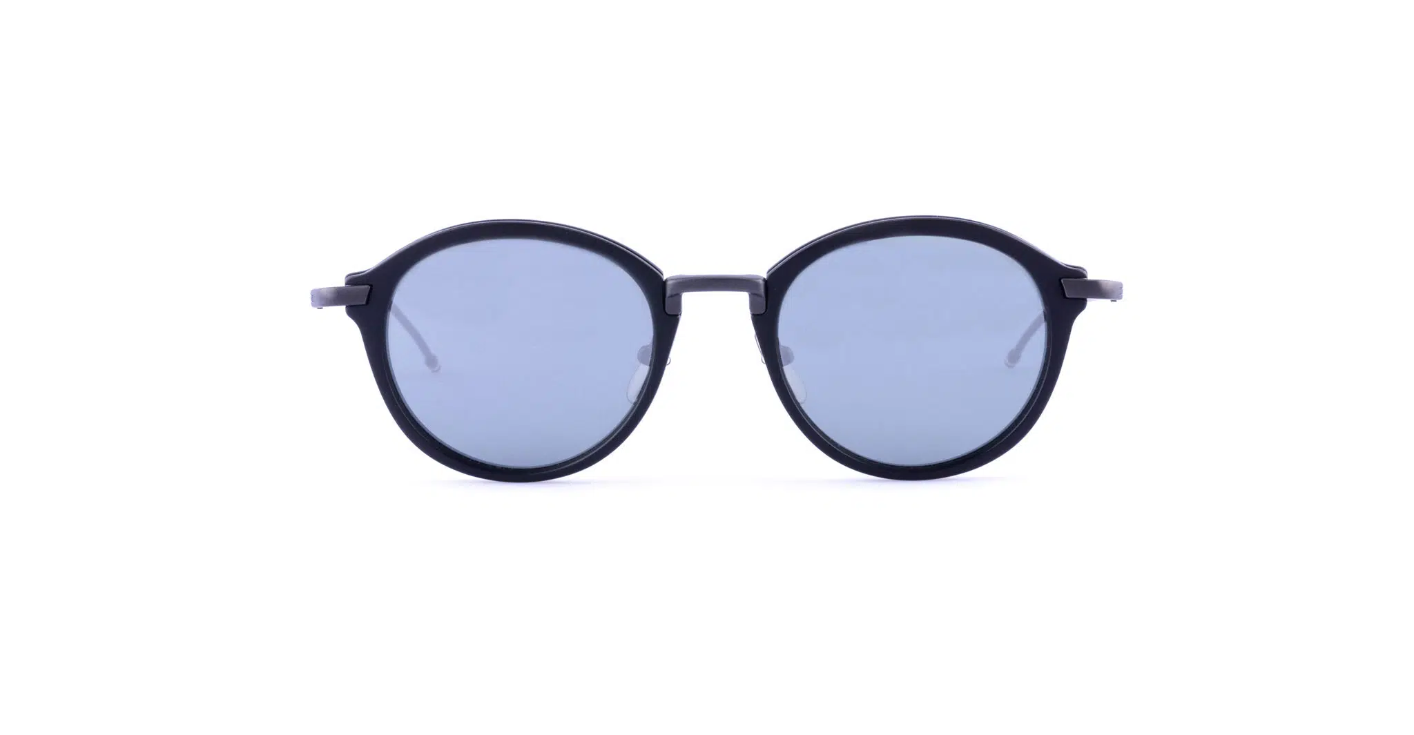 Round sunglasses with dark blue lenses and a black frame, positioned facing forward against a plain white background.