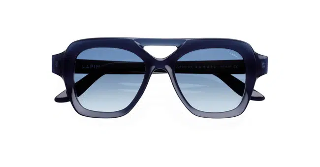 Lapima Samuel sunglasses feature bold, oversized square frames in dark blue. Shown from the front against a white background, these aviator-style shades have thick rims and gradient blue lenses.