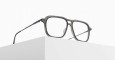 The Matsuda M2062, a pair of stylish eyeglasses with rectangular frames, rests on the edge of a white minimalist block against a plain white background.