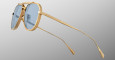 The Jacques Marie Mage Commander sunglasses, featuring gold frames, blue-tinted lenses, thin arms, and a double bridge design, are displayed in close-up against a light gray background.