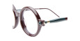 Close-up of Kuboraum P1 eyeglasses with round, thick burgundy frames and green temples featuring a small gold accent, shown against a white background.