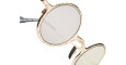 Close-up of Kuboraum Z17 round sunglasses with gold frames and tinted lenses, shown on a white background.
