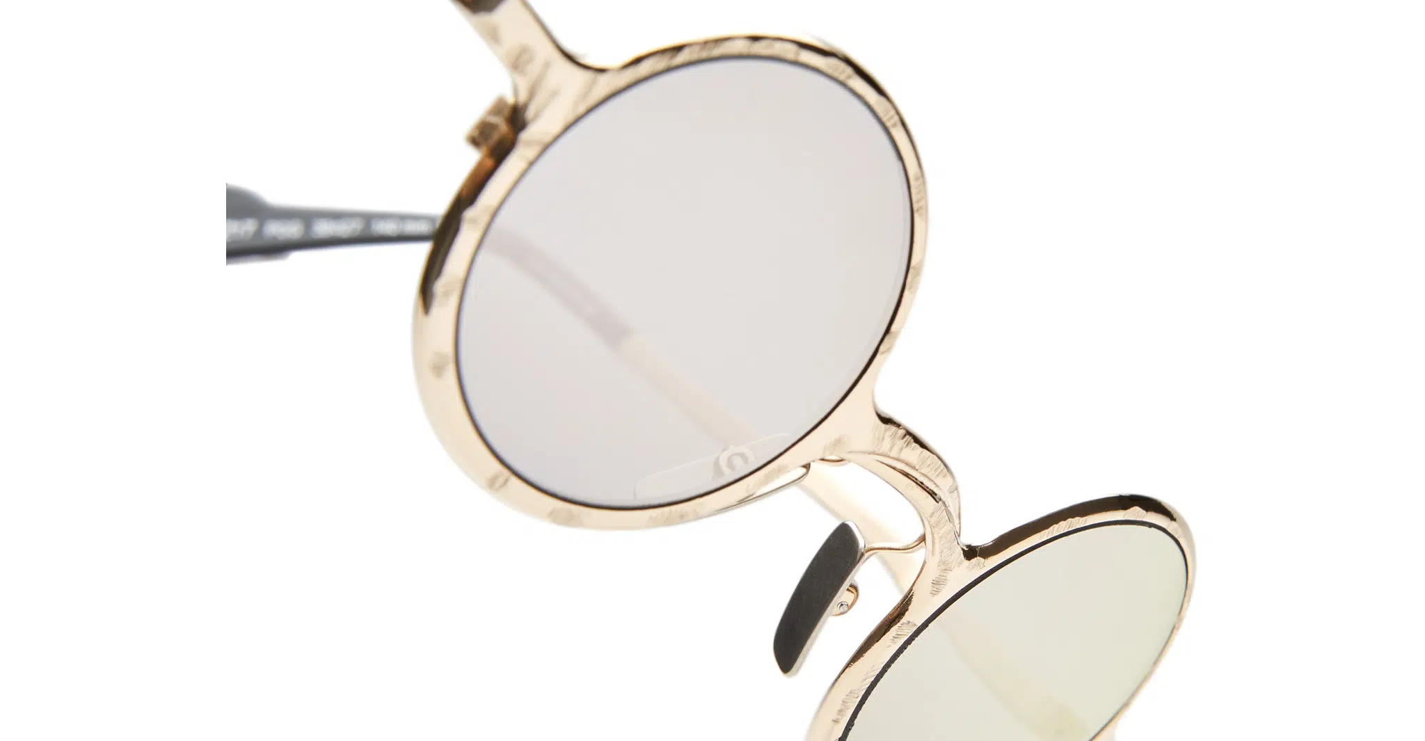 Close-up of Kuboraum Z17 round sunglasses with gold frames and tinted lenses, shown on a white background.