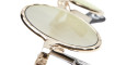 Close-up of Kuboraum Z17 gold-framed eyeglasses with light green lenses on a white background, showcasing the textured frame and curved design.