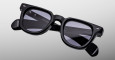 A pair of Jacques Marie Mage Vendome black rectangular sunglasses with thick frames and dark tinted lenses is displayed on a light gray background, with brand and model details visible on the inner temples.