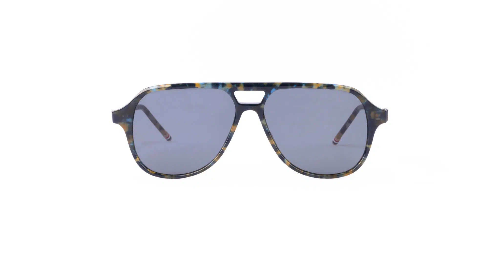 A pair of Thom Browne aviator sunglasses with blue-tinted lenses and a multicolored, tortoiseshell-style frame. The design features a straight top edge and a small cutout above the nose bridge.