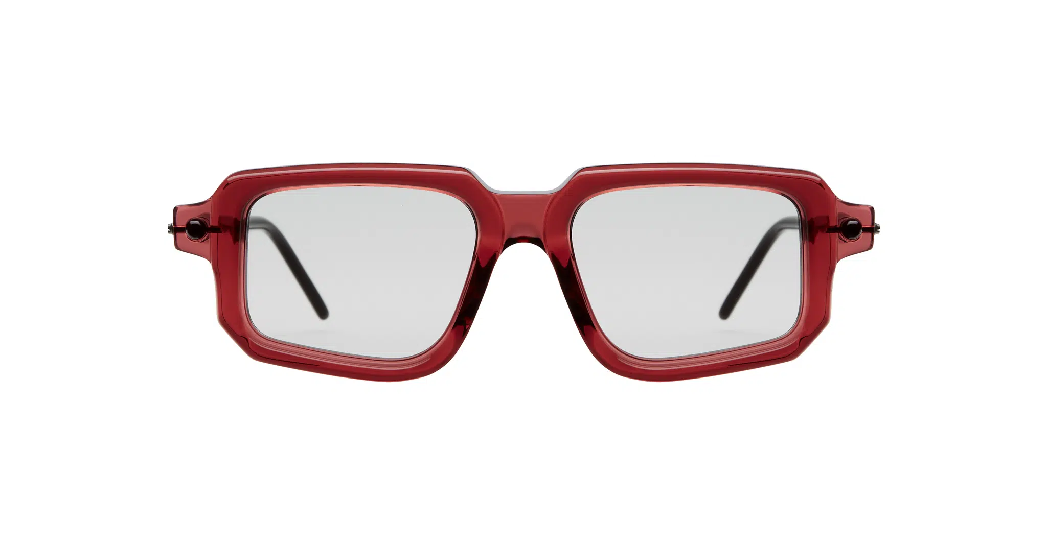 Kuboraum P23 bold square eyeglasses feature translucent red frames and clear lenses, seen from the front. The black temples are partially visible.