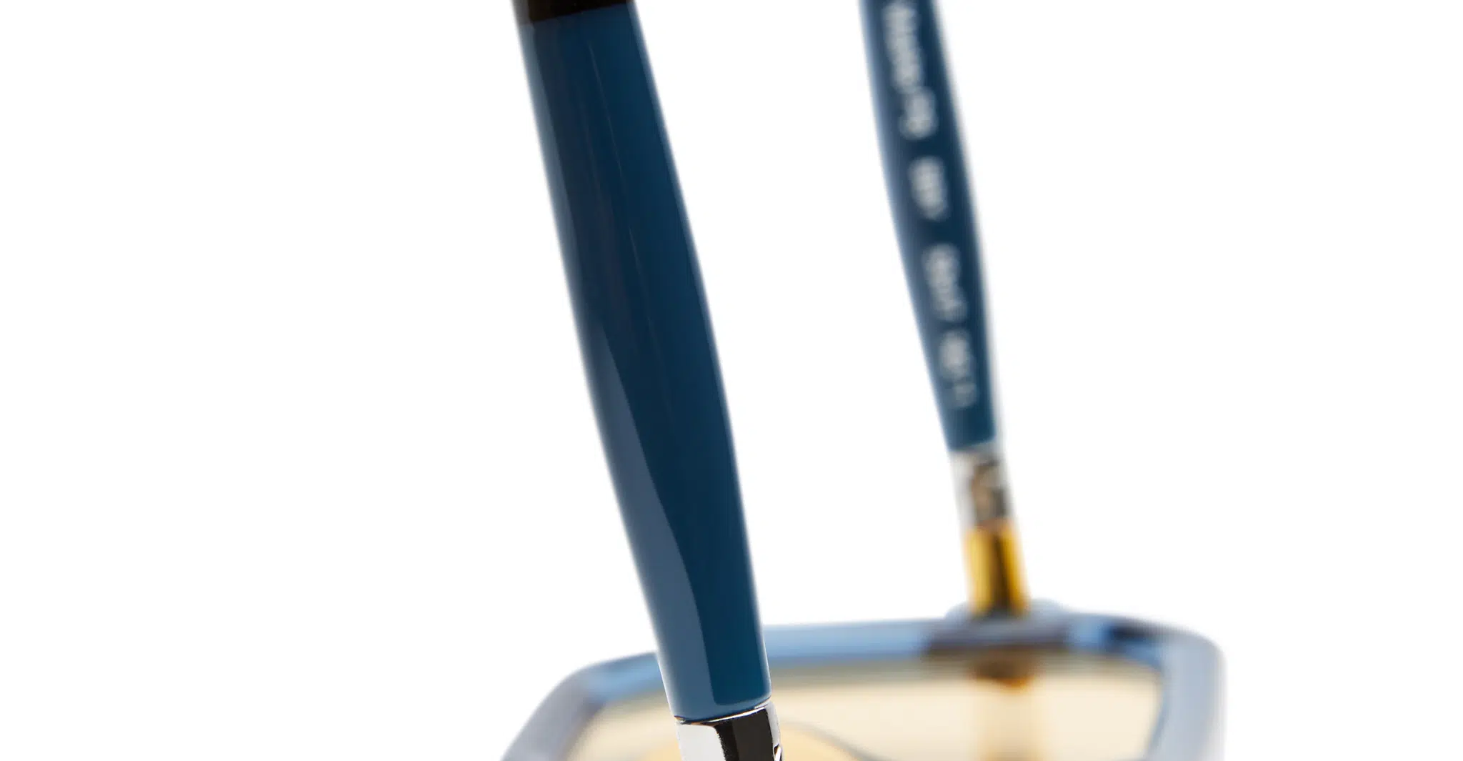 Kuboraum-P8-BBY-Biscay-Blue-KRS0P8BBY000002R-Detail4-Dan-Deutsch Close-up of the blue arms and upper frame of Kuboraum P8 eyeglasses, focusing on the temples against a blurred white background.