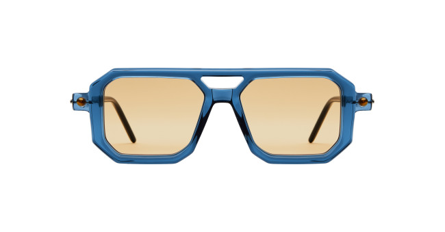 The Kuboraum P8 sunglasses feature thick blue geometric frames and light brown lenses, shown from the front against a white background.