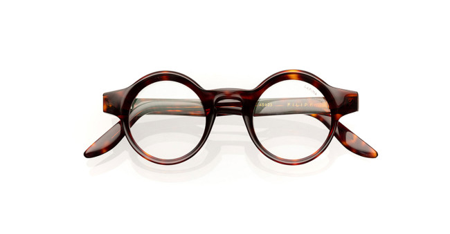 A pair of round, tortoiseshell eyeglasses with thick frames and clear lenses, displayed on a white background.