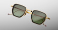 Jacques Marie Mage Atkins sunglasses feature a gold square frame, dark green lenses, and thin temples with red-accented tips, presented against a light gray background.