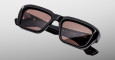 Jacques Marie Mage Walker sunglasses feature black rectangular frames with thick construction and brown-tinted lenses, shown on a light gray background. The WALKER name appears on the inside of one arm.