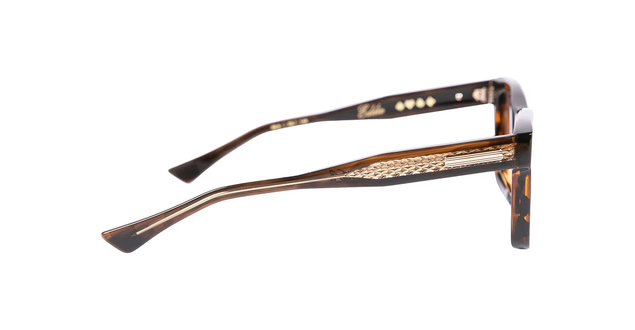 A close-up side view of Native Sons x Casinola "The E's" brown tortoiseshell eyeglasses with gold detailing on the arms, shown against a white background.