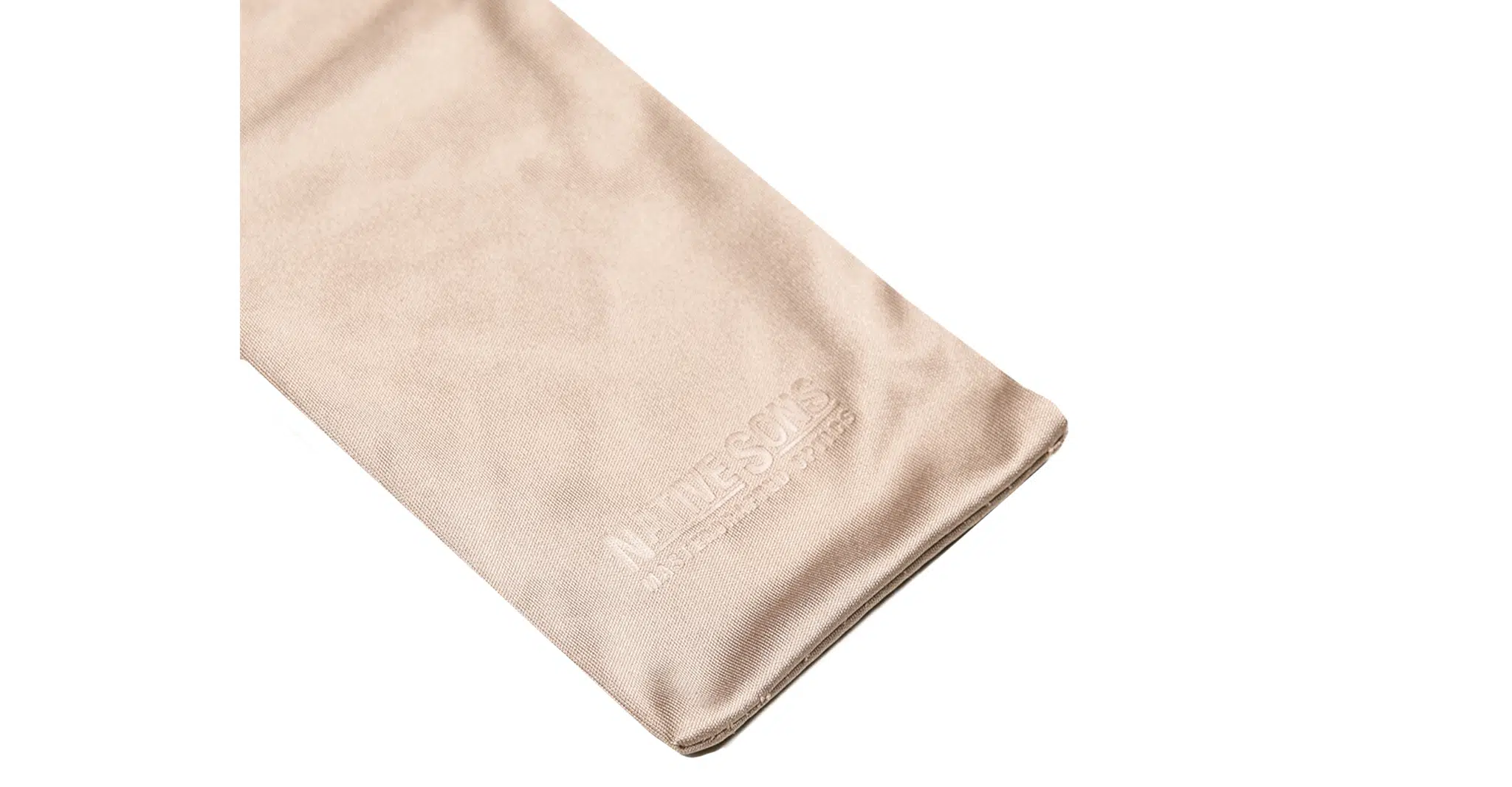 A beige suede cleaning cloth for the Native Sons x Casinola "The E's," subtly embossed in white in the lower corner, set against a white background.