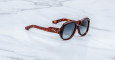 Jacques Marie Mage Ocean Child tortoiseshell sunglasses with dark, rounded lenses displayed on a white marble surface.