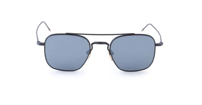 Front view of Thom Browne Sunglasses featuring square, blue-tinted lenses and a thin black metal frame. The slim temples curve slightly at the ends, complemented by a double bridge above the nose pads.