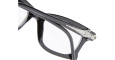 Close-up of Kuboraum D75 black eyeglass frames with a glossy finish and clear lenses, featuring a silver metallic Iron Man helmet detail on the temple.