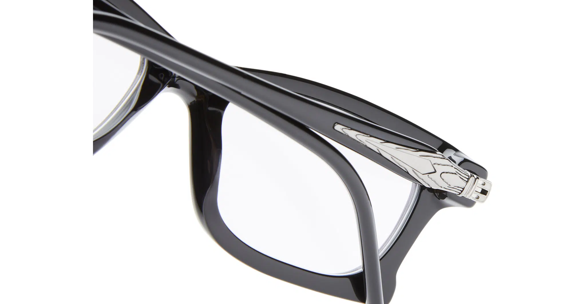 Close-up of Kuboraum D75 black eyeglass frames with a glossy finish and clear lenses, featuring a silver metallic Iron Man helmet detail on the temple.