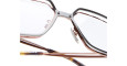 Close-up of Kuboraum H15 eyeglasses with brown frames and clear lenses, highlighting the nose pads and arms against a white background.