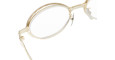 Close-up of Kuboraum H18 gold-rimmed round eyeglasses with clear lenses, highlighting the frame, nose pads, and left temple against a white background.