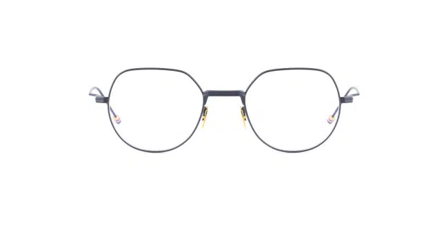 Thom Browne 935: Black round eyeglasses with a thin metal frame, gold accents on the nose bridge and hinges, and clear lenses, displayed against a white background.